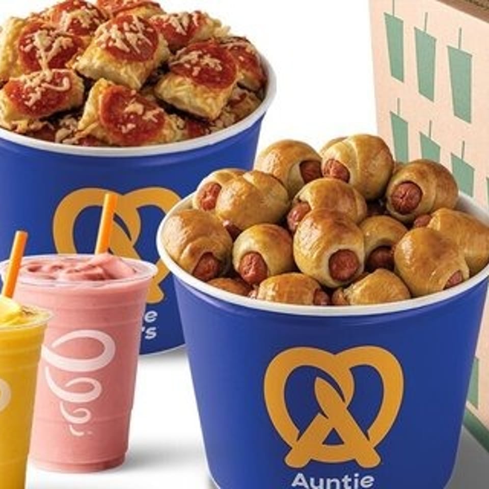 Auntie Anne's pretzel nuggets and mini pretzel dogs in blue buckets, with three Jamba smoothies and a box.